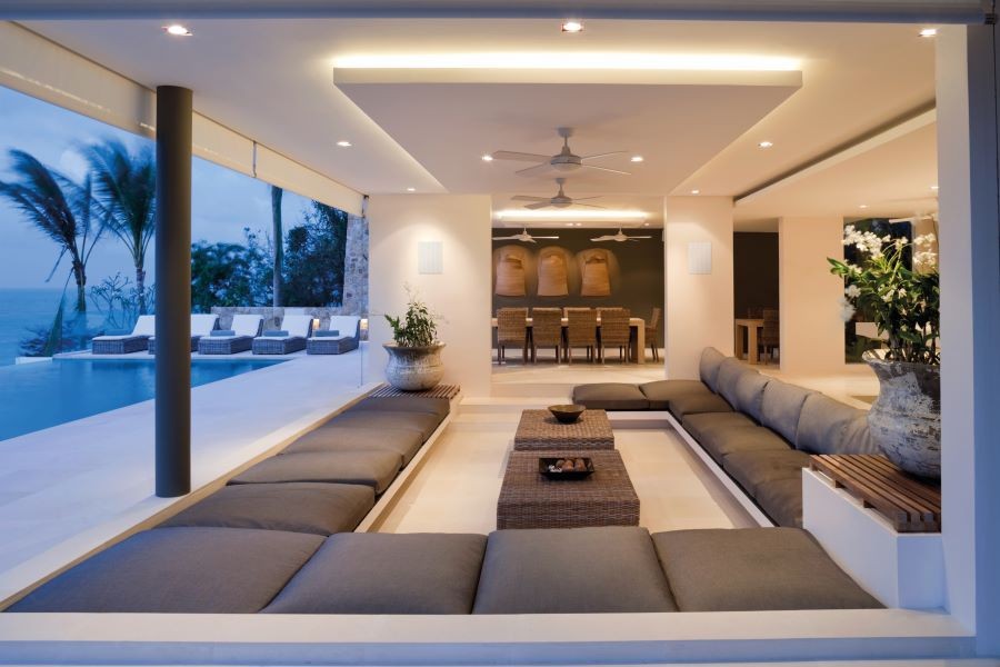 Open room with in-wall speakers overlooking pool and ocean.   Author: Marisa Upson 