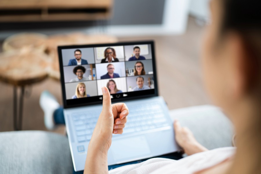 A woman video conferencing on her laptop with others remotely.